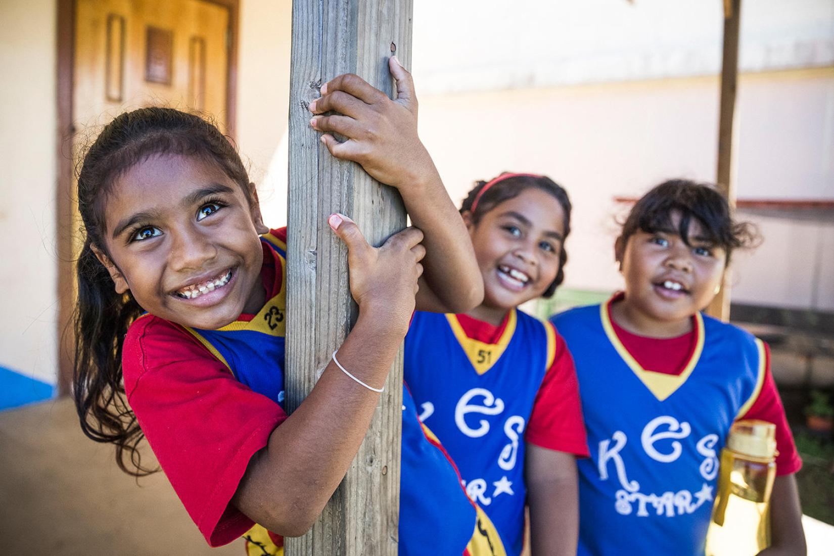 Children smiling at the camera.