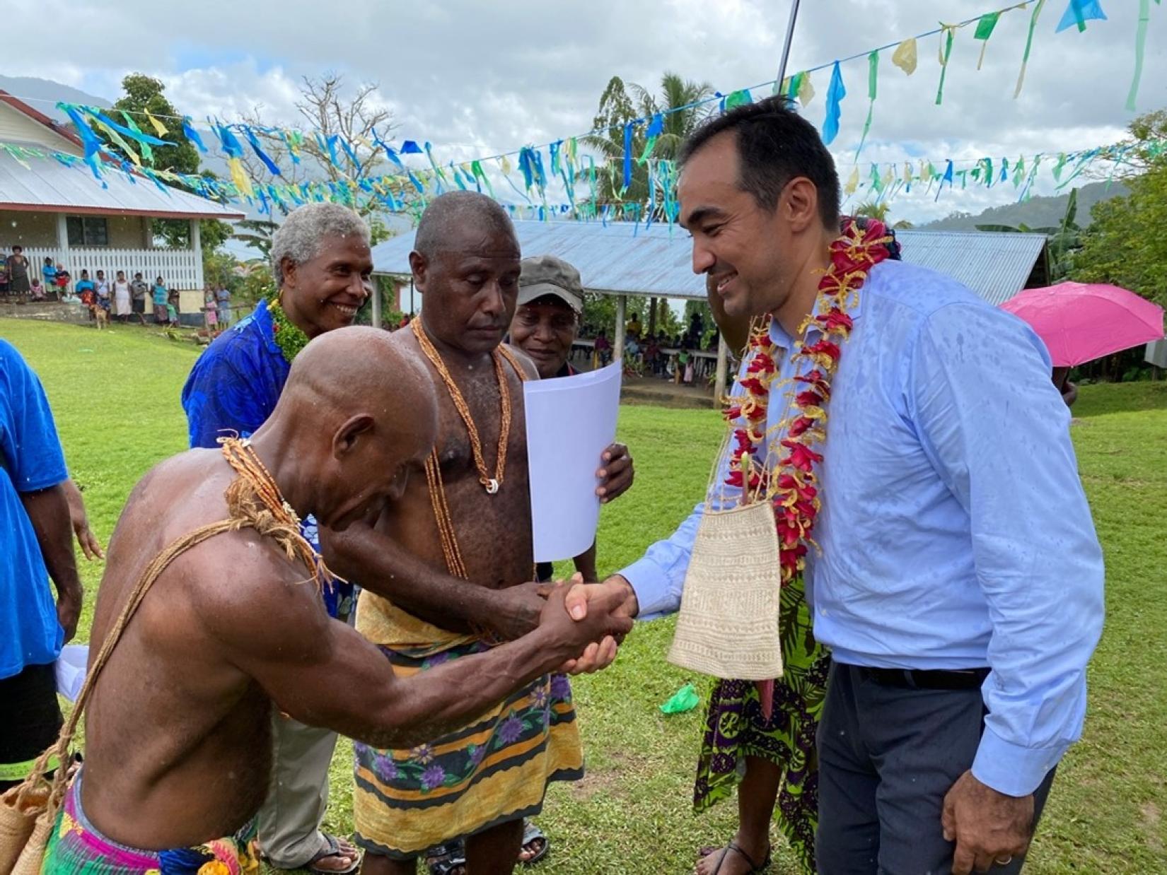 Mr Berdi Berdiyev, UNDP Country Manager in Solomon Islands shakes hands after handing over the certificates of customary land recording completion to chiefs of Raroasi customary landholding group; Photo credit: UNDP Solomon Islands.